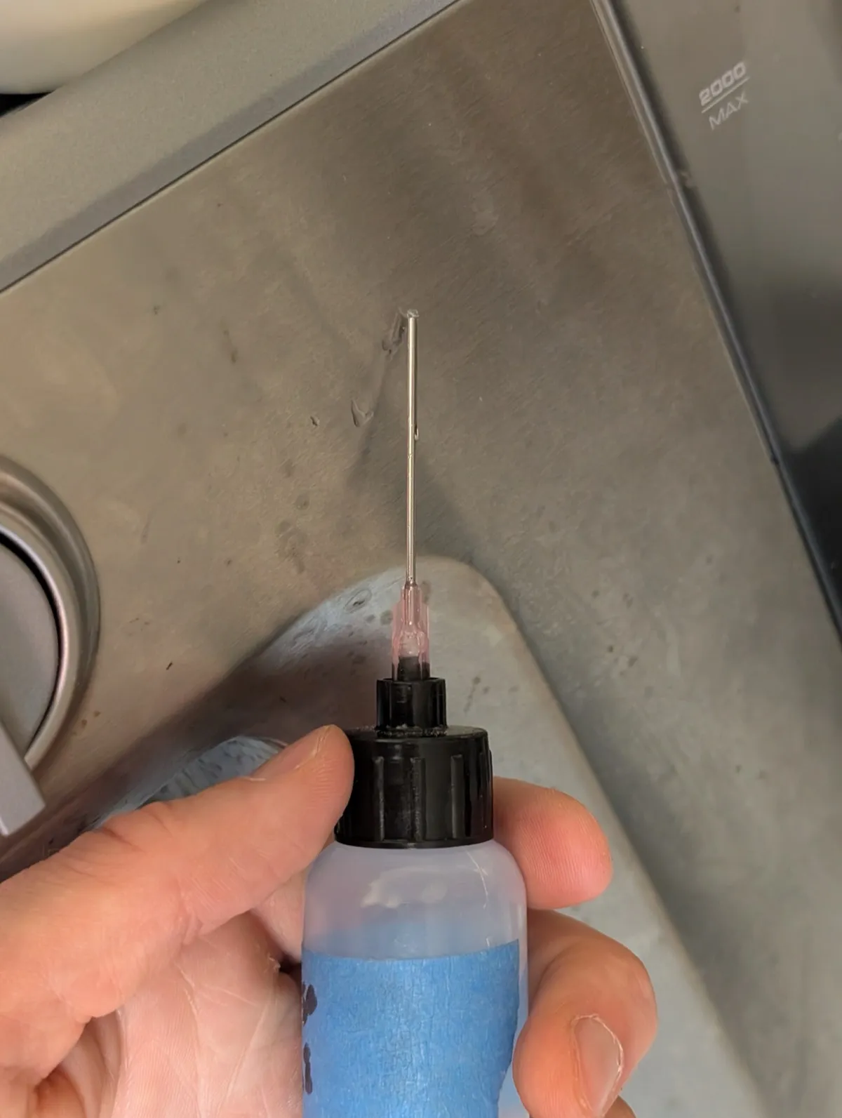 A bottle of Super Lube Synthetic Oil with a needle-tip applicator